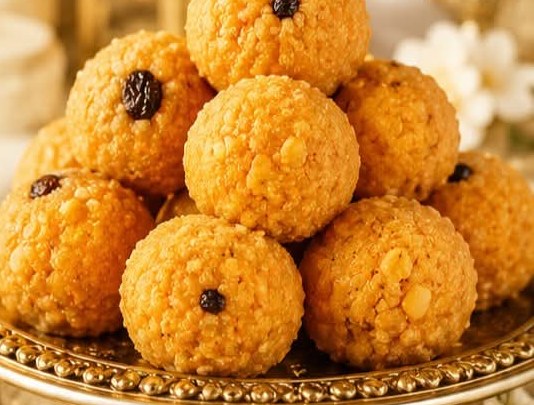 Stack of fresh laddoo on a gold platter